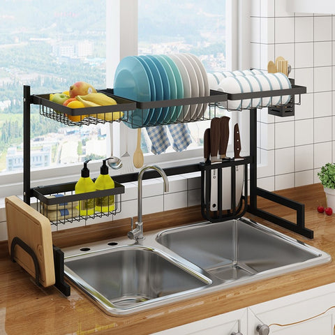 Close up of dish drying rack with dishes and utensils