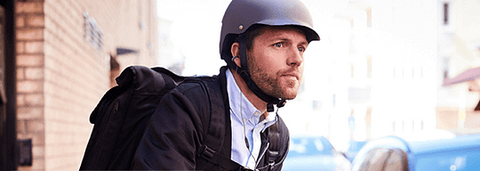 Person wearing ear clip bone conduction headphones while running outdoors.