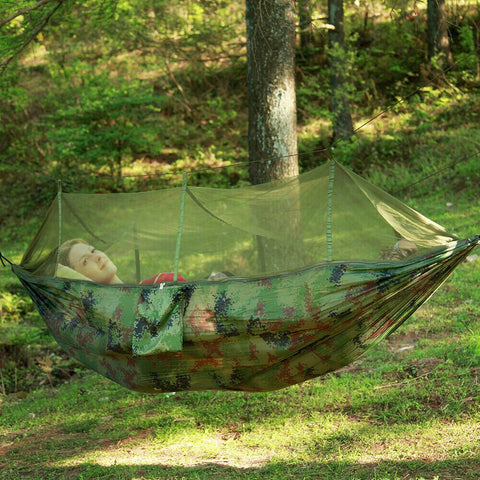 Portable two person camping hammock tent with canopy set up outdoors